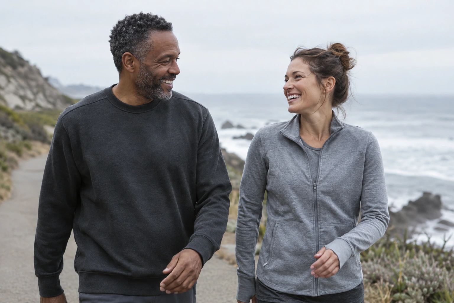 Two adults talking during a coastal walk