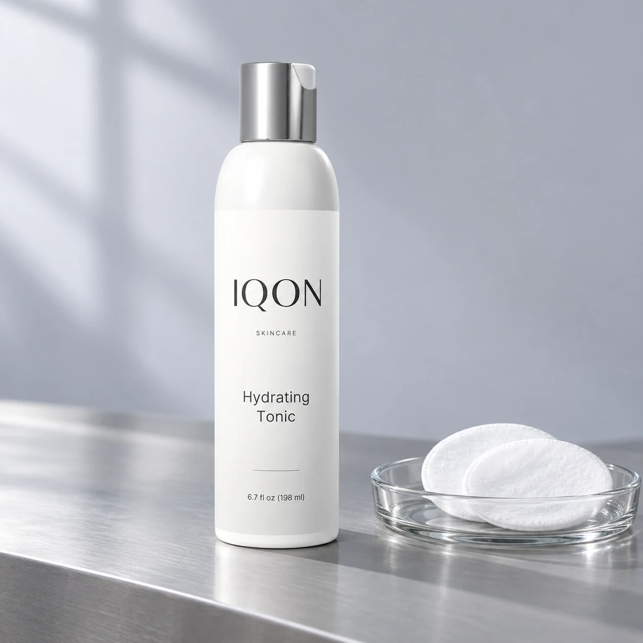 IQON Hydrating Tonic with cotton pads and a glass dish