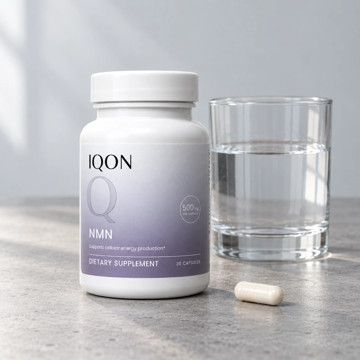 IQON NMN beside a glass of water and one ivory capsule